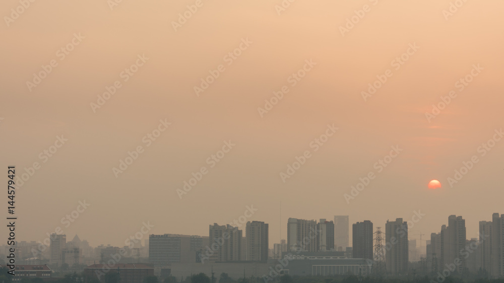 High angle horizontal building shot of sunset in beijing on a foggy day