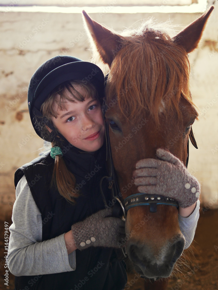 Fototapeta premium Child is hugging a horse.