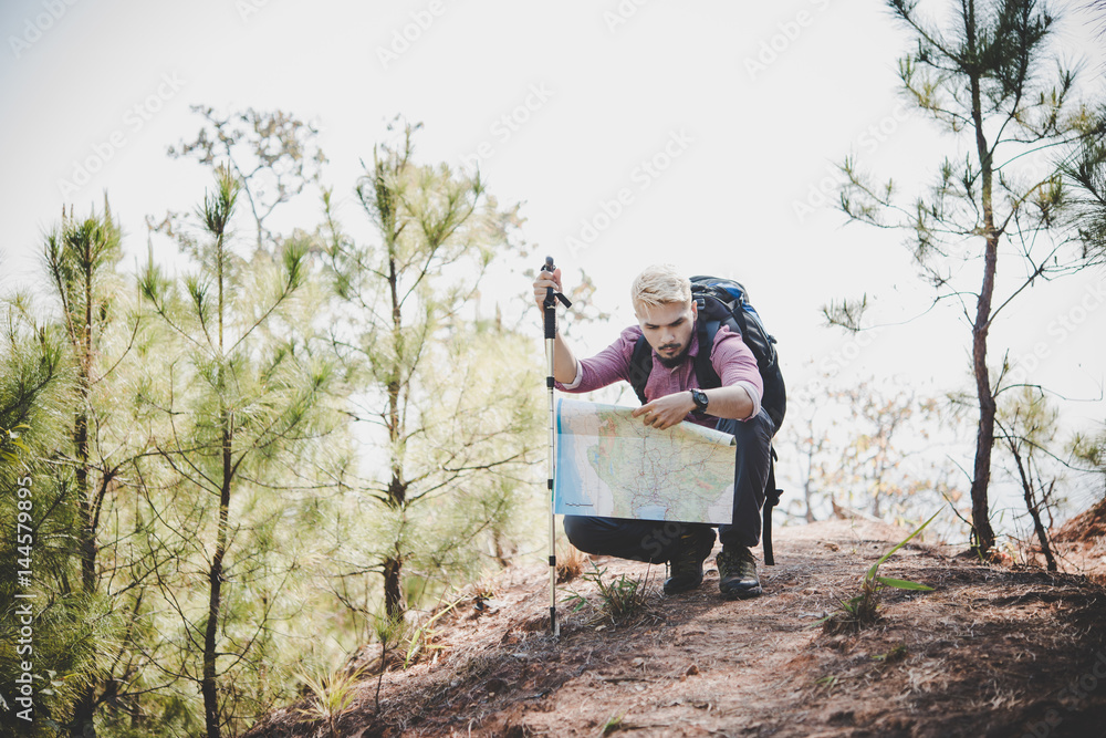 Hiker with map and big traveling backpack traveling to the mountain. Hiker with map and big traveling backpack traveling to the mountain.
