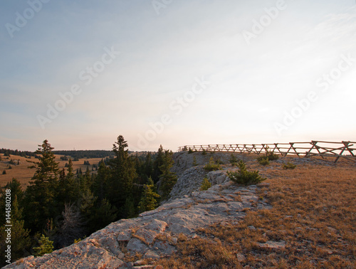 Split Rail Fence at sunrise above Lost Water Canyon in the Pryor Mountains Wild Horse range on the Montana Wyoming state line USA