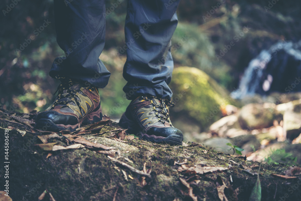 Close up of adventure man feet walk on a mountain path. Close up of adventure man feet walk on a mountain path.