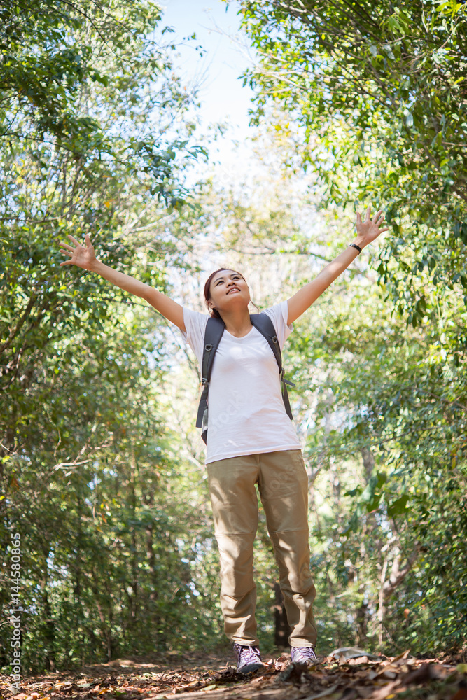 Attractive woman hiker open arms at mountain while hiking, Enjoy with nature. Travel concept.