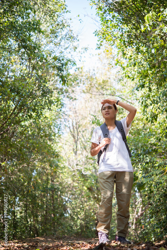 Active young woman hiker walking though the forest enjoy with nature.