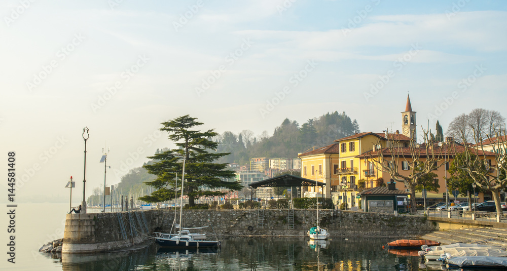 Scene of small town with dock and lake in Italy