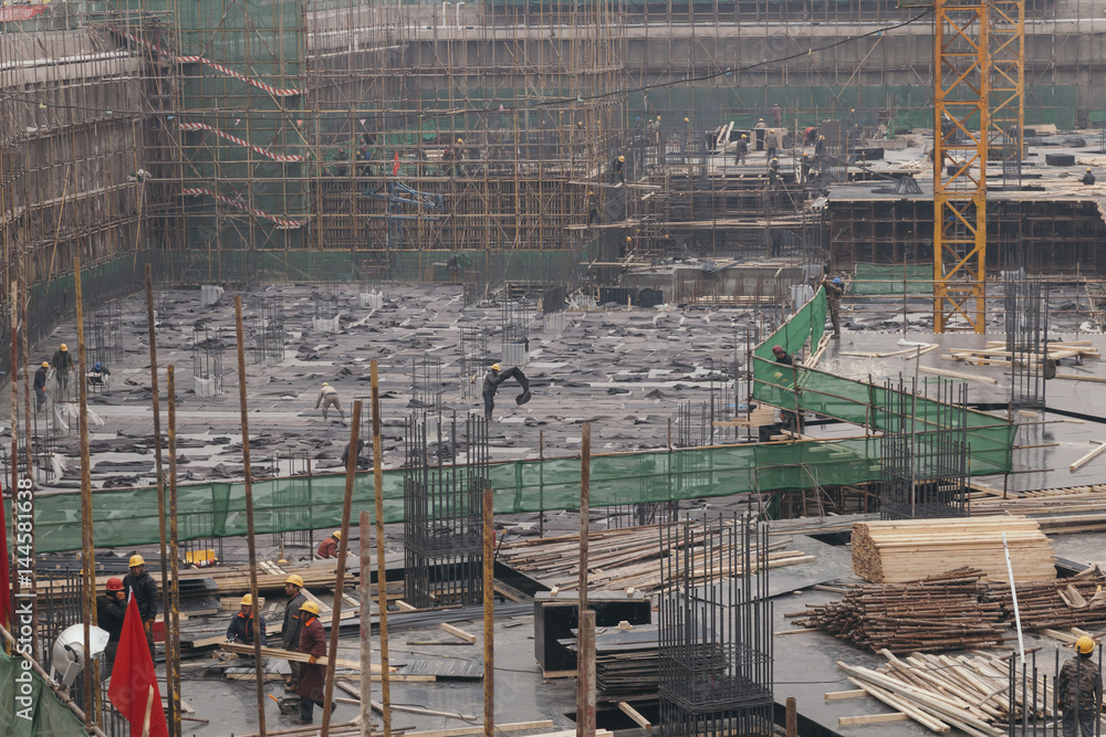 18 Dec,2014 Beijing. Work activity on a construction site in City with cranes and workers,building train station