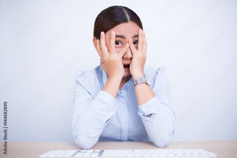 Asian woman make the scared gesture at office