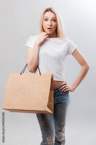 Portrait of pretty woman hold shopping bag. Female model isolated studio background.