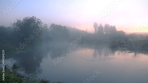 Foggy autumn landscape with forest river