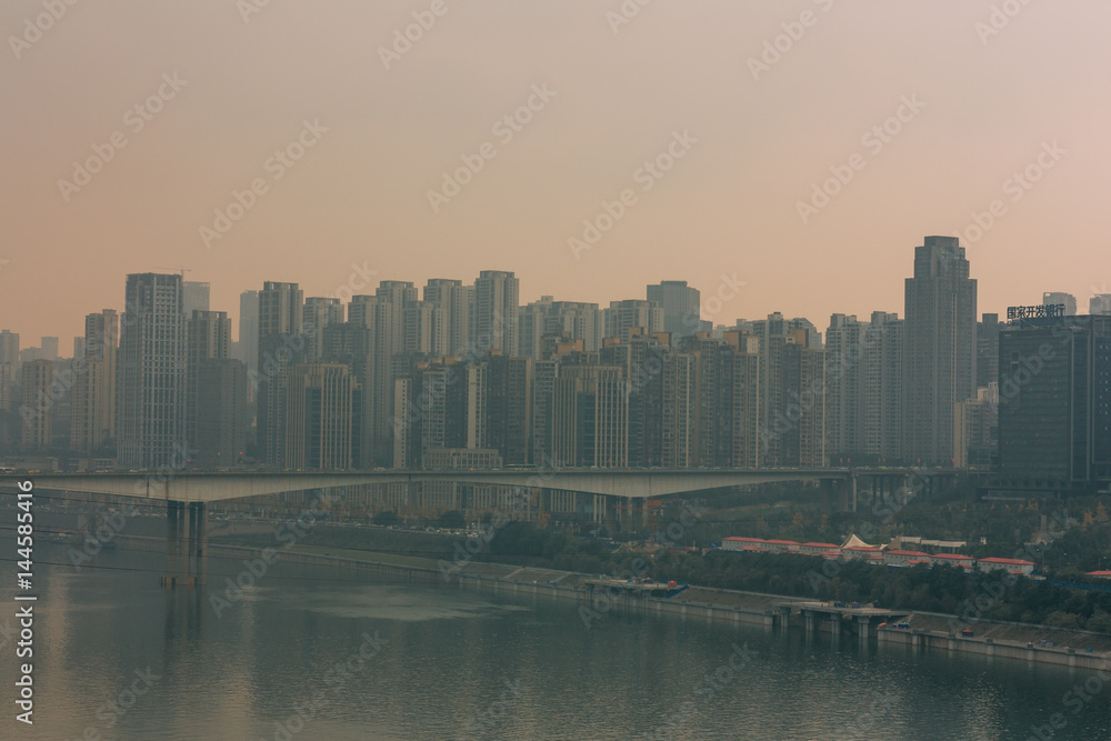 Obraz premium Chongqing, China - Dec 22, 2015: The view of foggy crowded city bridges beside the jialing river