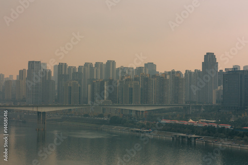 Chongqing, China - Dec 22, 2015: The view of foggy crowded city bridges beside the jialing river