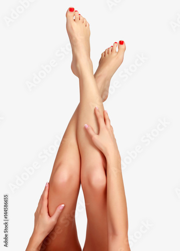 Woman's legs on light grey background, isolated