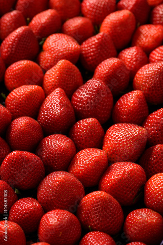 Fresh ripe strawberries as background.