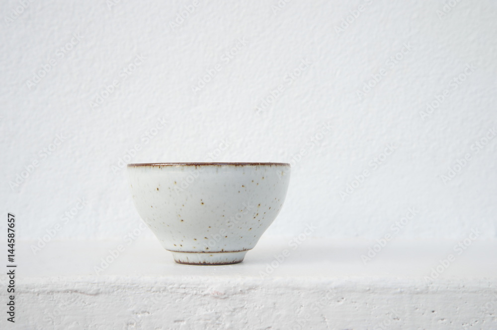 white ceramic tea cup with cement wall background - obrazy, fototapety, plakaty 