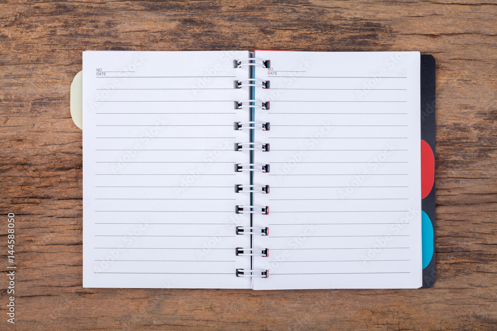 Blank empty notepad on wood background Blank empty notepad on wood background