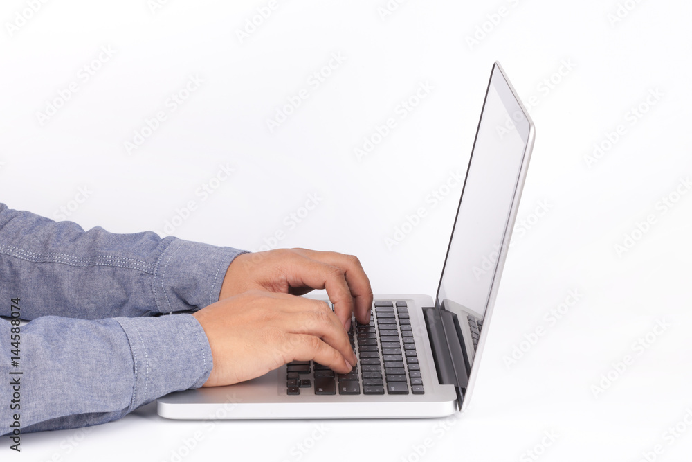Hands typing on keyboard of laptop on white background Hands typing on keyboard of laptop on white background