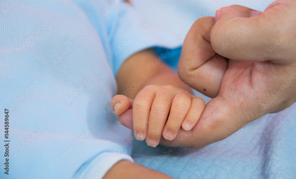 Close up mother finger holding baby hand Close up mother finger holding baby hand