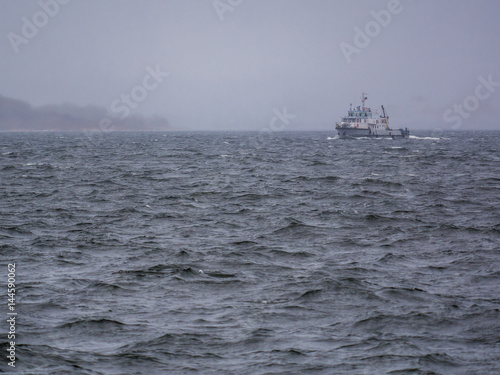 boat on the river and waves during a storm