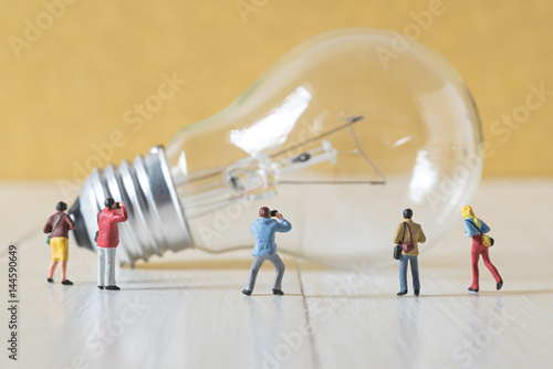 miniature photographer take a picture of vintage light bulb photo