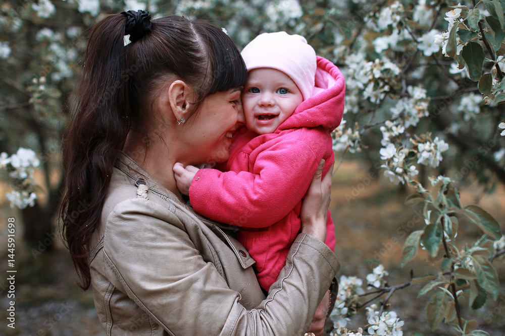Obraz premium Mother with baby in summer garden sunny day forest tree