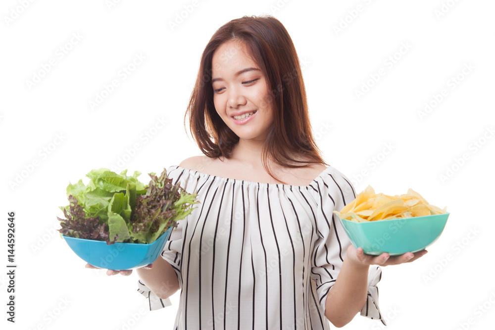 Young Asian woman with potato chips and salad. Young Asian woman with potato chips and salad.