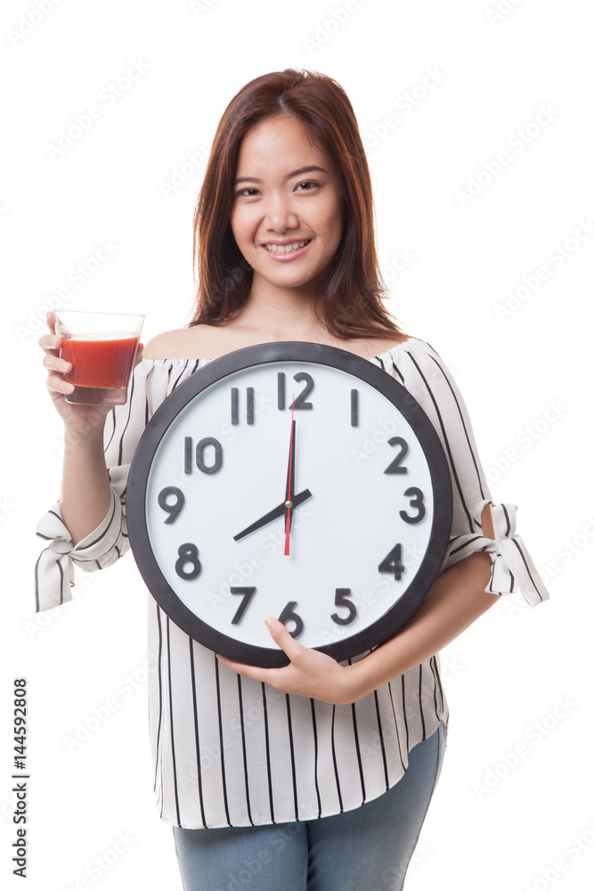 Young Asian woman with tomato juice and clock. Young Asian woman with tomato juice and clock.