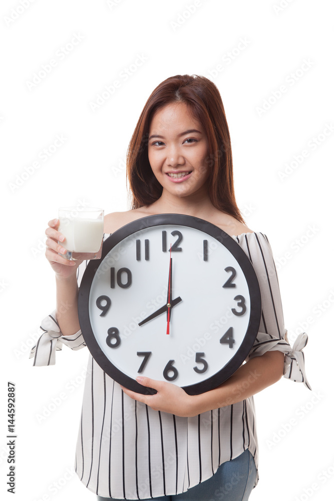 Healthy Asian woman drinking glass of milk hold clock. Healthy Asian woman drinking glass of milk hold clock.