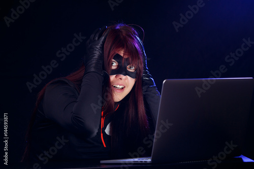 Surprised brunette next to laptop