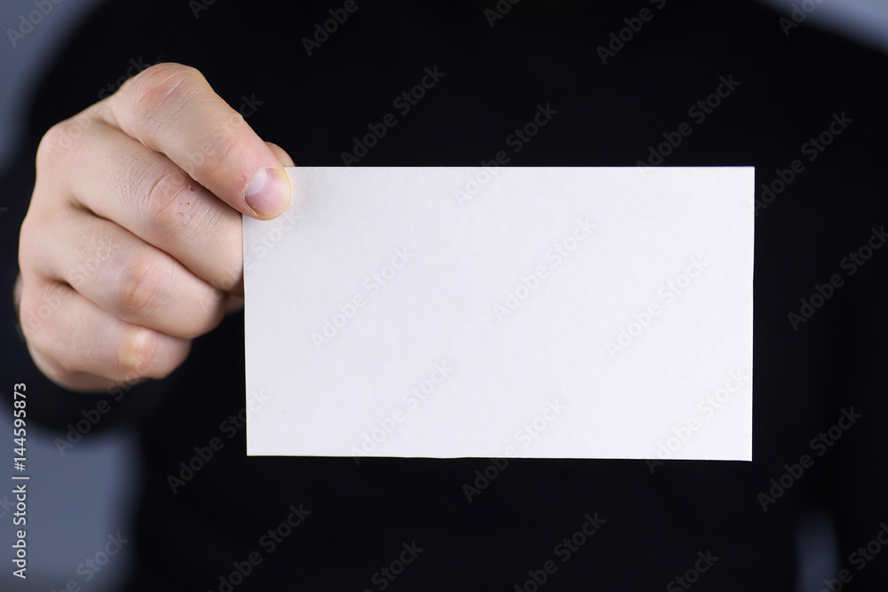 small white piece of paper in his hand man small white piece of paper in his hand man