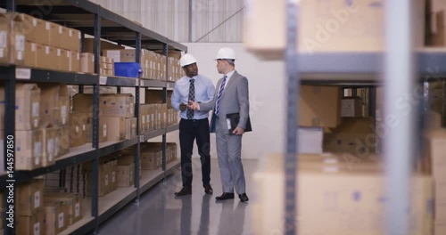 Wallpaper Mural  2 Businessmen in discussion as they walk through industrial warehouse Torontodigital.ca