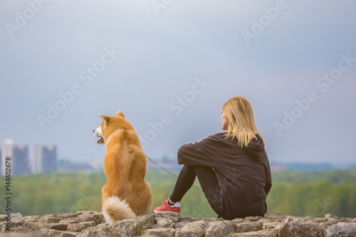 Girl with her akita dog pet 