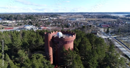 Halikko watertower, Cinema 4k landing tilt aerial view of Halikko water tower, on a sunny spring day, in Salo, Finland photo