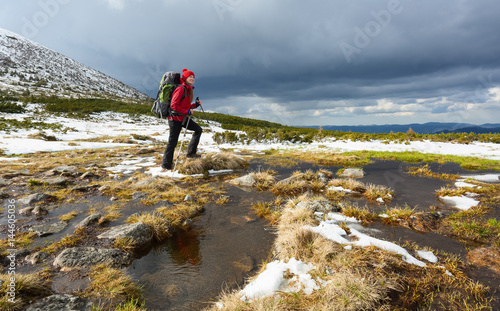 Dreamy blonde girl walking with great sport backpack.