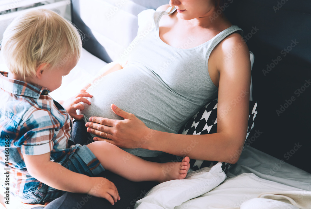 Pregnant mother and son at home.