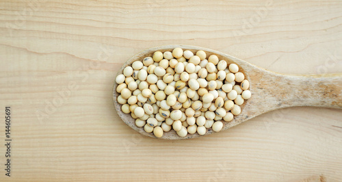 soybean in a spoon on a wooden background.