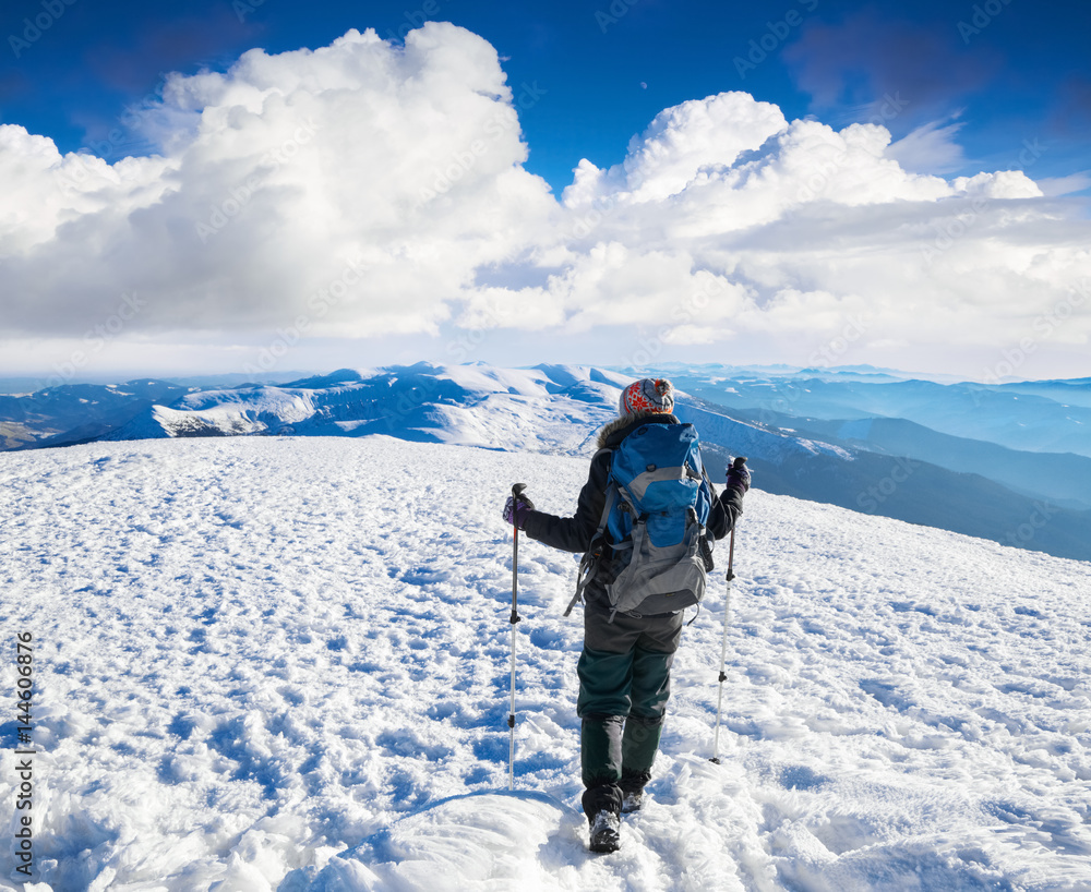 Dreaming girl is sitting on snowy hill at the high mountains. Dreaming girl is sitting on snowy hill at the high mountains.