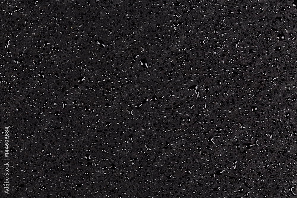 Water drops on dark stone Water drops on dark stone