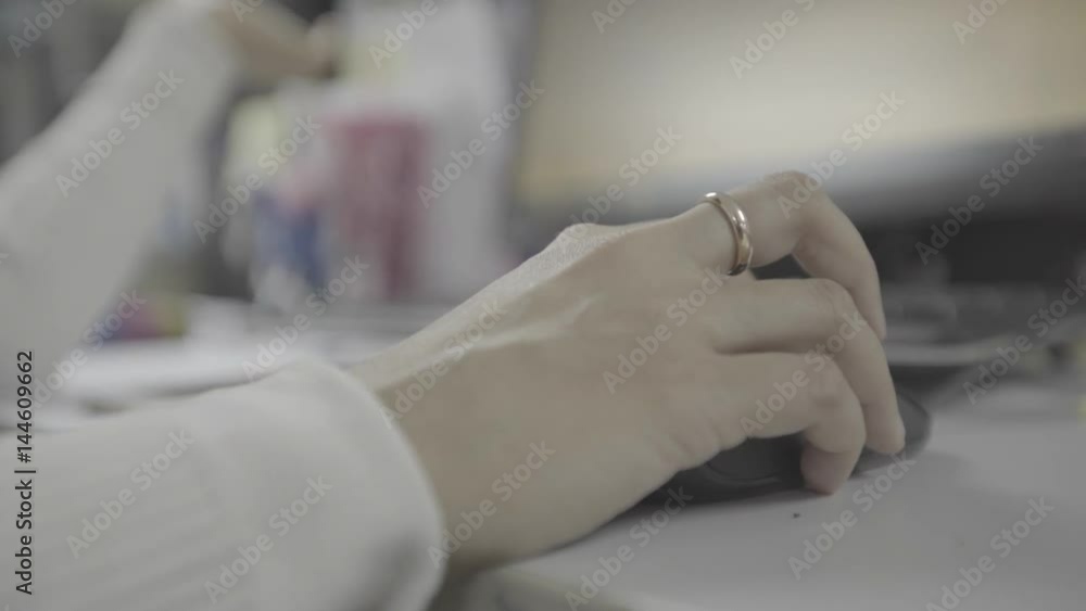 computer mouse in woman hand on office desk computer mouse in woman hand on office desk