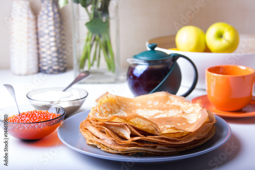 Traditional Russian pancakes with caviar and sour cream. Maslennitsa. Selective focus photo