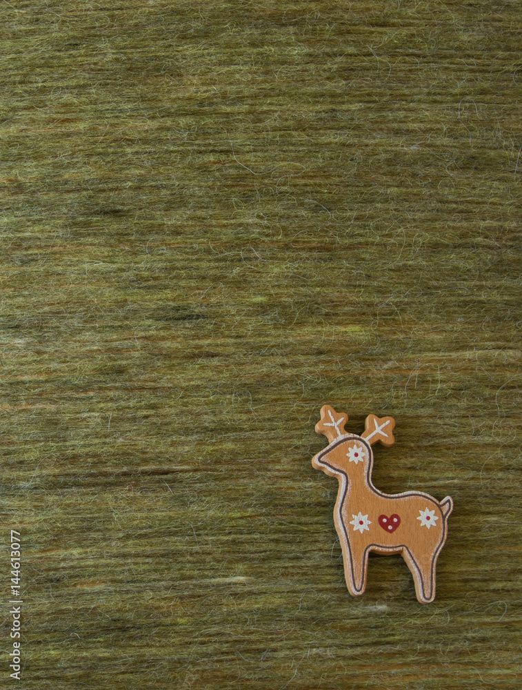 Christmas deer on a green wool background