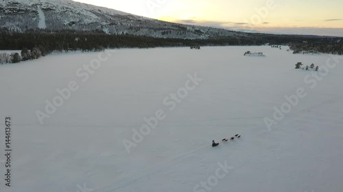 Aerial view of a dog sledge on a remote lake