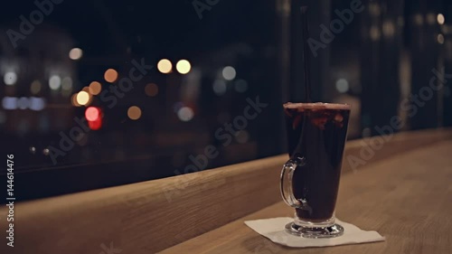 Glass with cocktail on bar table photo