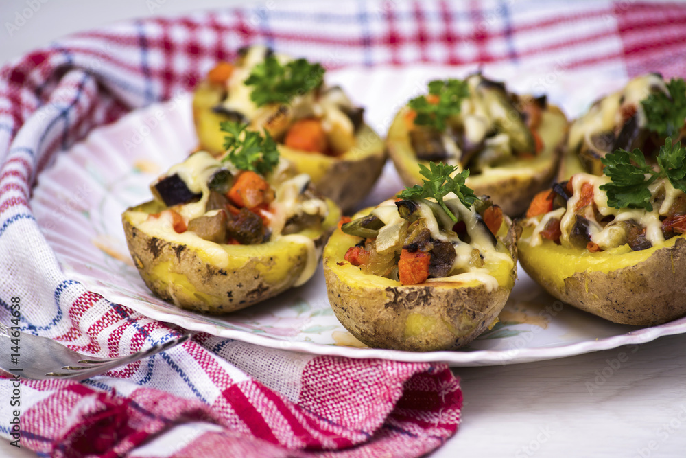 Baked potatoes stuffed with vegetables and cheese