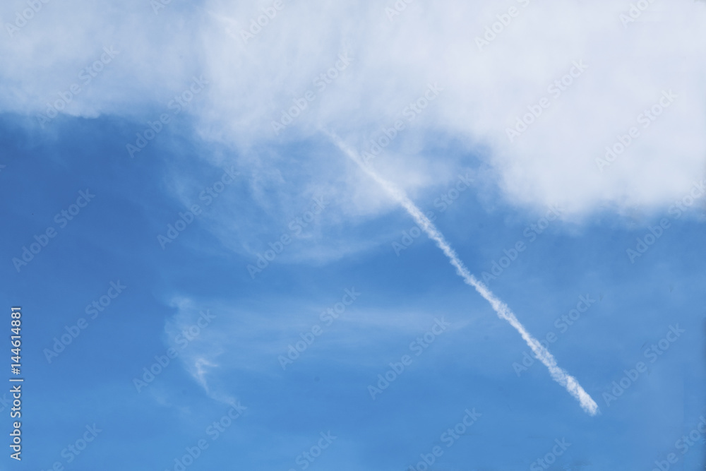 Blue sky with a slightly white line through soft cloud. Blue sky with a slightly white line through soft cloud.