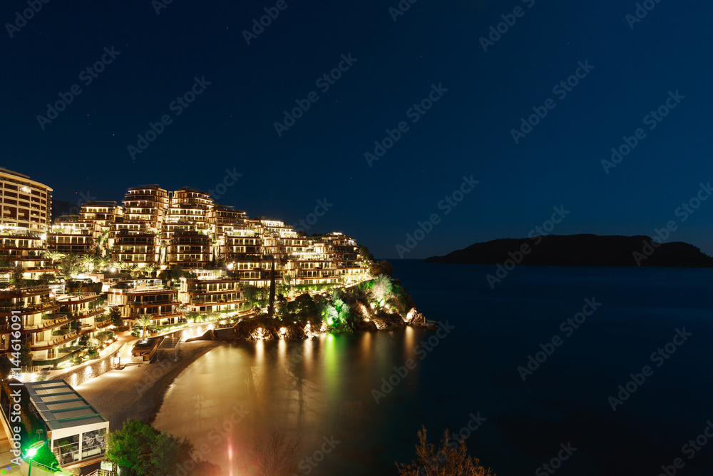 Hotel complex for rich people Dukley Gardens in Budva, Montenegro. Night photo at the full moon, starry sky.