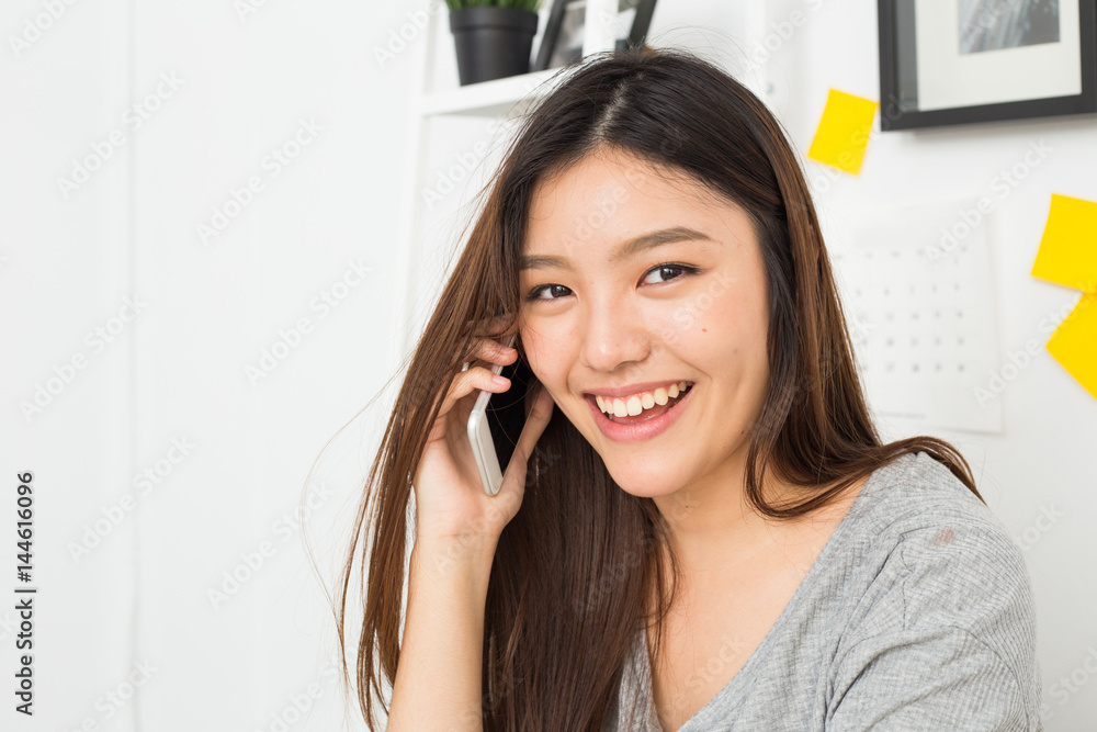 Young asian lady talking on phone Young asian lady talking on phone