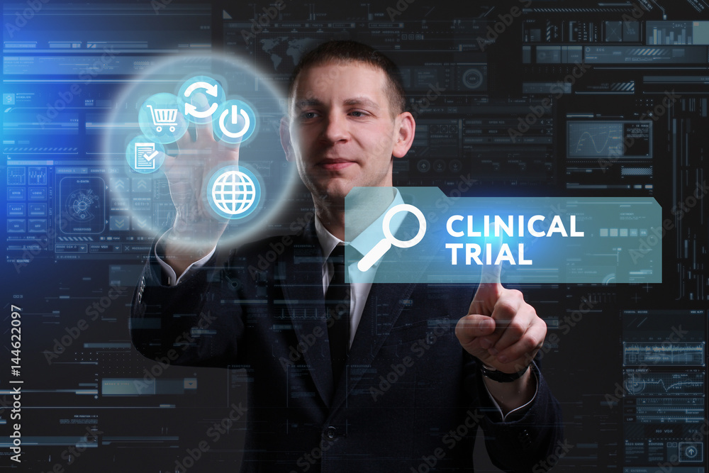Business, Technology, Internet and network concept. Young businessman working on a virtual screen of the future and sees the inscription: Clinical trial Business, Technology, Internet and network concept. Young businessman working on a virtual screen of the future and sees the inscription: Clinical trial