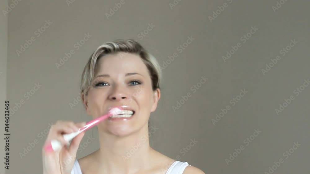 Beautyful woman brushing her white teeth Beautyful woman brushing her white teeth
