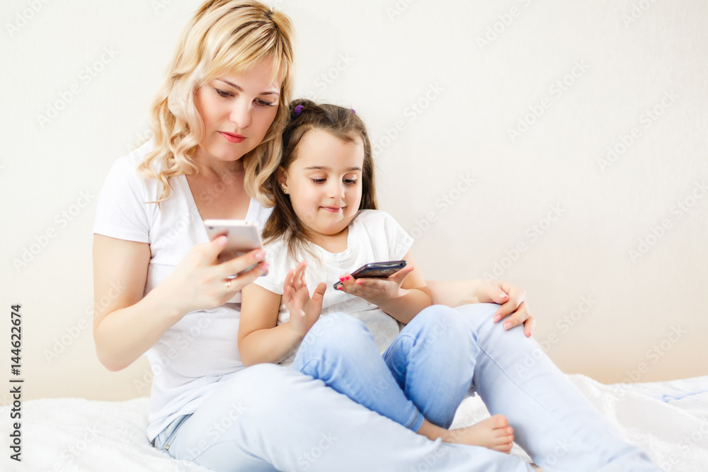 Indian mother and child playing game on the smartphone Indian mother and child playing game on the smartphone