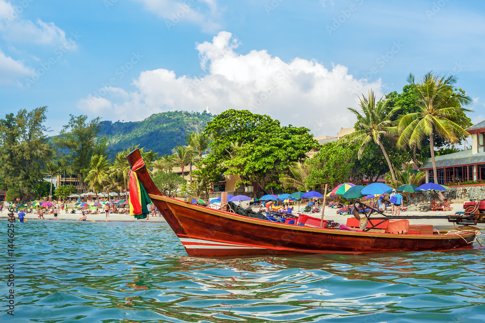 Traditional Thai long boat on Kata beach - one of the best beaches in Phuket, Thailand 