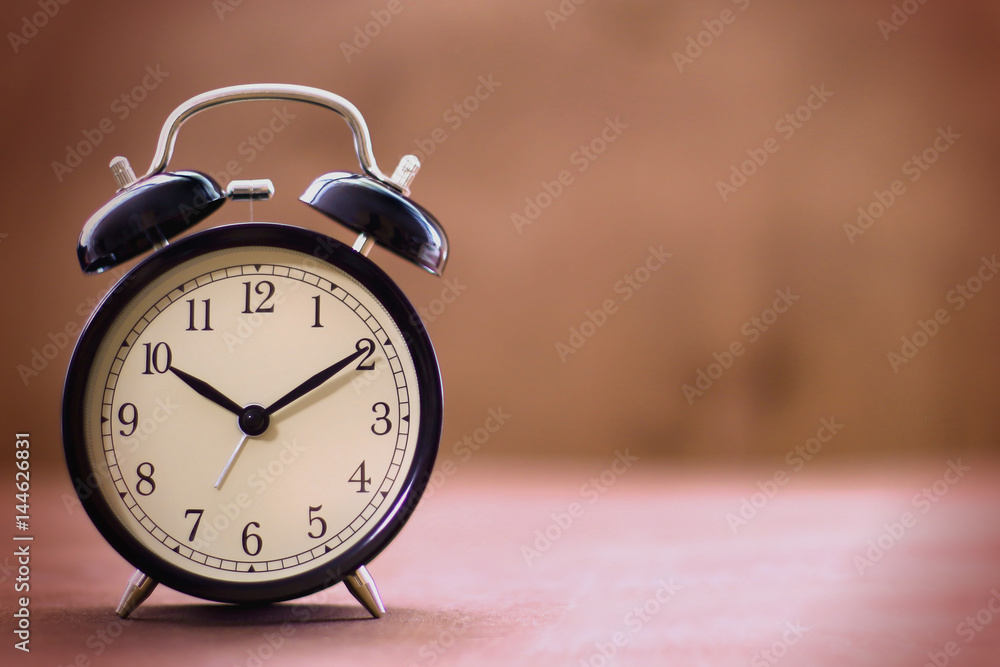 Old fashioned alarm clock with copy space on a blurred background Old fashioned alarm clock with copy space on a blurred background